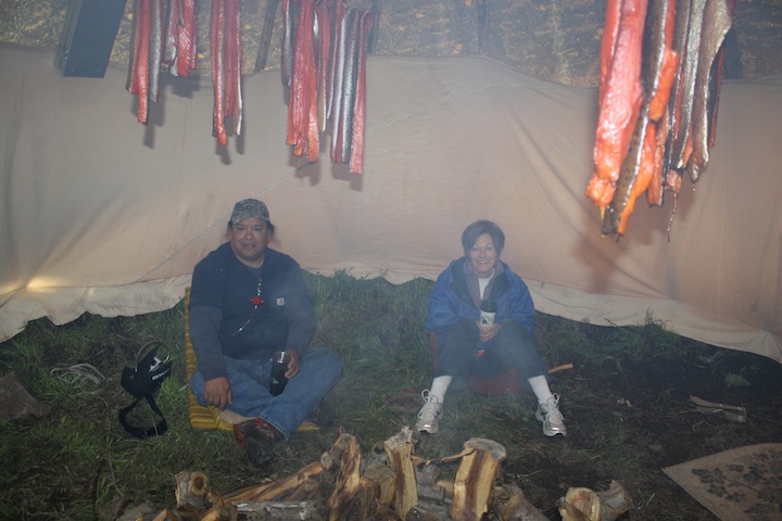 Stuart Harris and Anna Harding in a tipi smoking salmon
