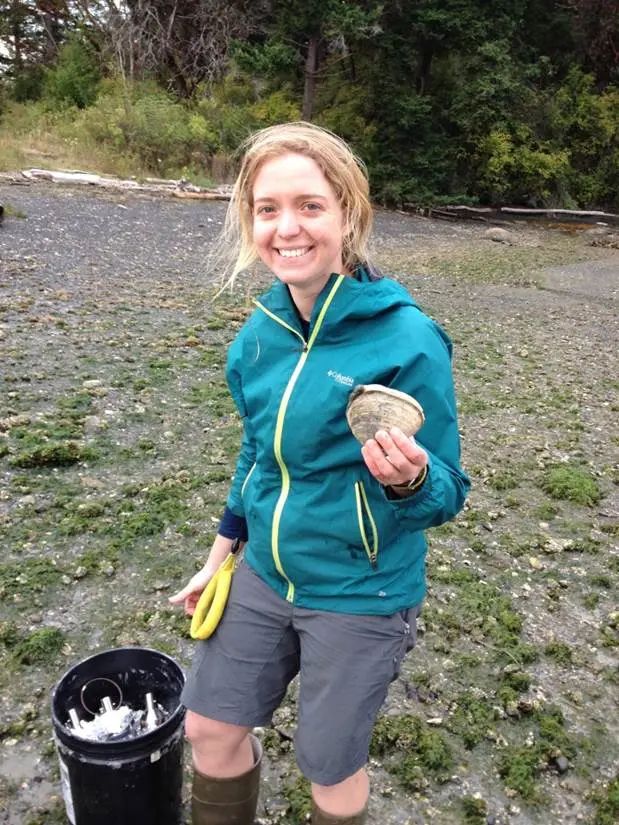 FSES Researcher holding a clam while sampling